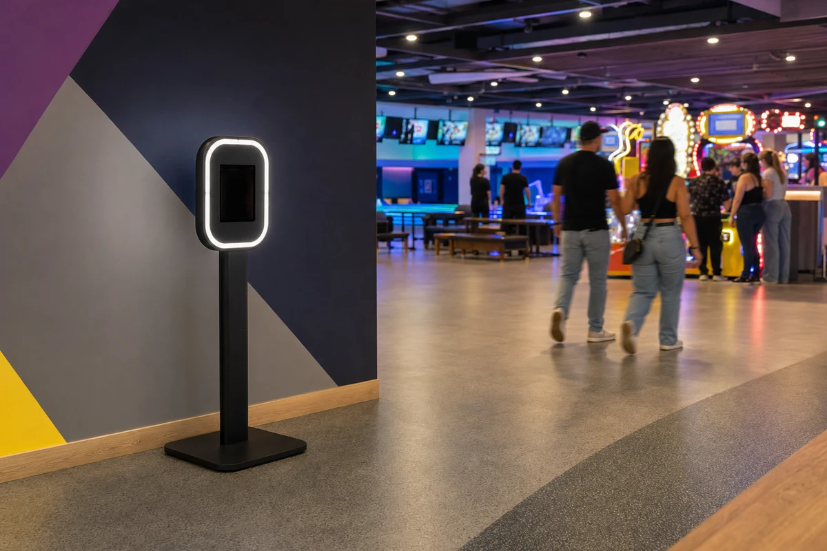 An iPad photo booth installed as a permanent, unattended fixture against a feature wall in a family entertainment venue.